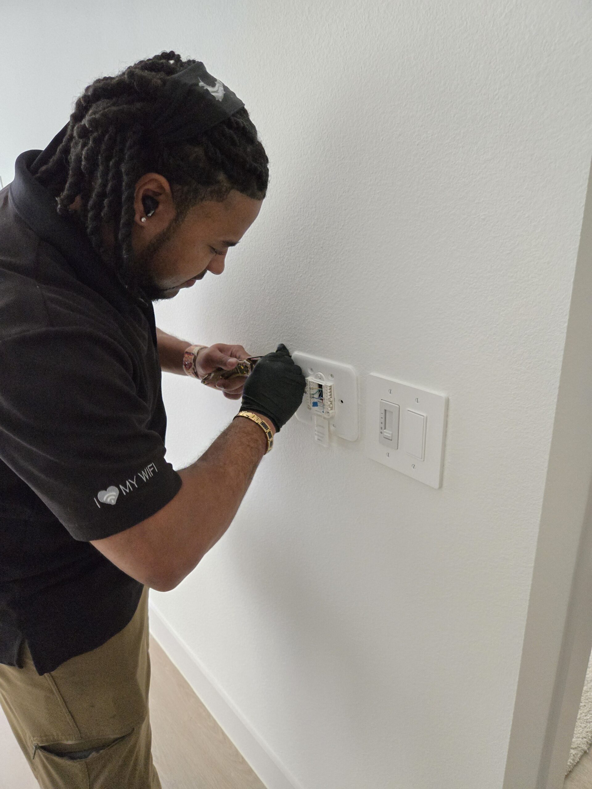 Technician configuring integrated smart home controls with careful system testing and setup